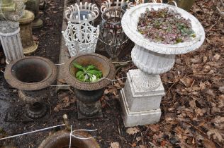 A PAIR OF EARLY 20th CENTURY CAST IRON GARDEN URNS with fluted baluster bowl height 46cm and a