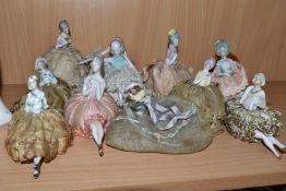 A GROUP OF LATE 19TH AND EARLY 20TH CENTURY PORCELAIN PIN DOLLS, nine pin cushion dolls and one