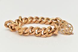 A YELLOW METAL CURB LINK BRACELET, hollow links alternating between floral patterned and plain