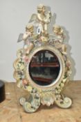AN EARLY 20TH CENTURY SITZENDORF PORCELAIN FLORAL ENCRUSTED AND FIGURAL MIRROR, modelled with
