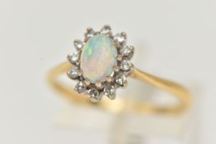 AN OPAL AND DIAMOND CLUSTER RING, the central oval opal cabochon within a single cut diamond