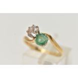 A DIAMOND AND EMERALD TWO STONE RING, an old cut diamond, approximate total diamond weight 0.65ct,
