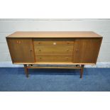 POSSIBLY GORDON RUSSELL, A MID CENTURY TEAK SIDEBOARD, fitted with two cupboard doors, flanking