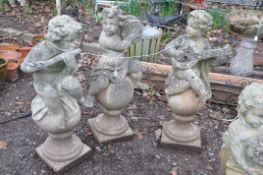 A SET OF THREE MOULDED GARDEN FIGURES IN THE FORM OF CHILDREN EACH PLAYING A MUSICAL INSTRUMENT