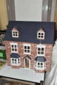A MODERN THREE STOREY DOLLS HOUSE OF LATE VICTORIAN STYLE, with papered red brick effect exterior,