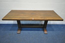 A 20TH CENTURY OAK REFECTORY TABLE, raised on chamfered block supports, shaped feet, united by a