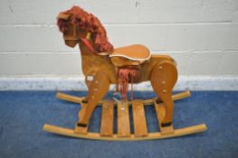 A PINE FRAMED ROCKING HORSE (condition report: tail loose, surface marks, scuffs, other signs of