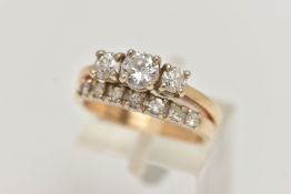 TWO YELLOW METAL DIAMOND RINGS, three round brilliant cut diamonds prong set in yellow metal,