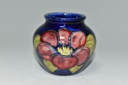 A MOORCROFT POTTERY SQUAT BALUSTER VASE, decorated with Clematis on a blue ground, impressed and