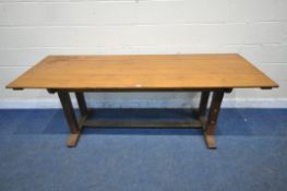 A 20TH CENTURY OAK REFECTORY TABLE, raised on four block supports, shaped feet, united by a