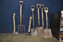 A COLLECTION OF WOODEN HANDLED VINTAGE GARDEN TOOLS including three spades, a shovel , a fork, a