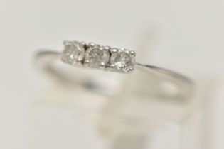 A PLATINUM THREE STONE DIAMOND RING, designed as a line of three brilliant cut diamonds in claw