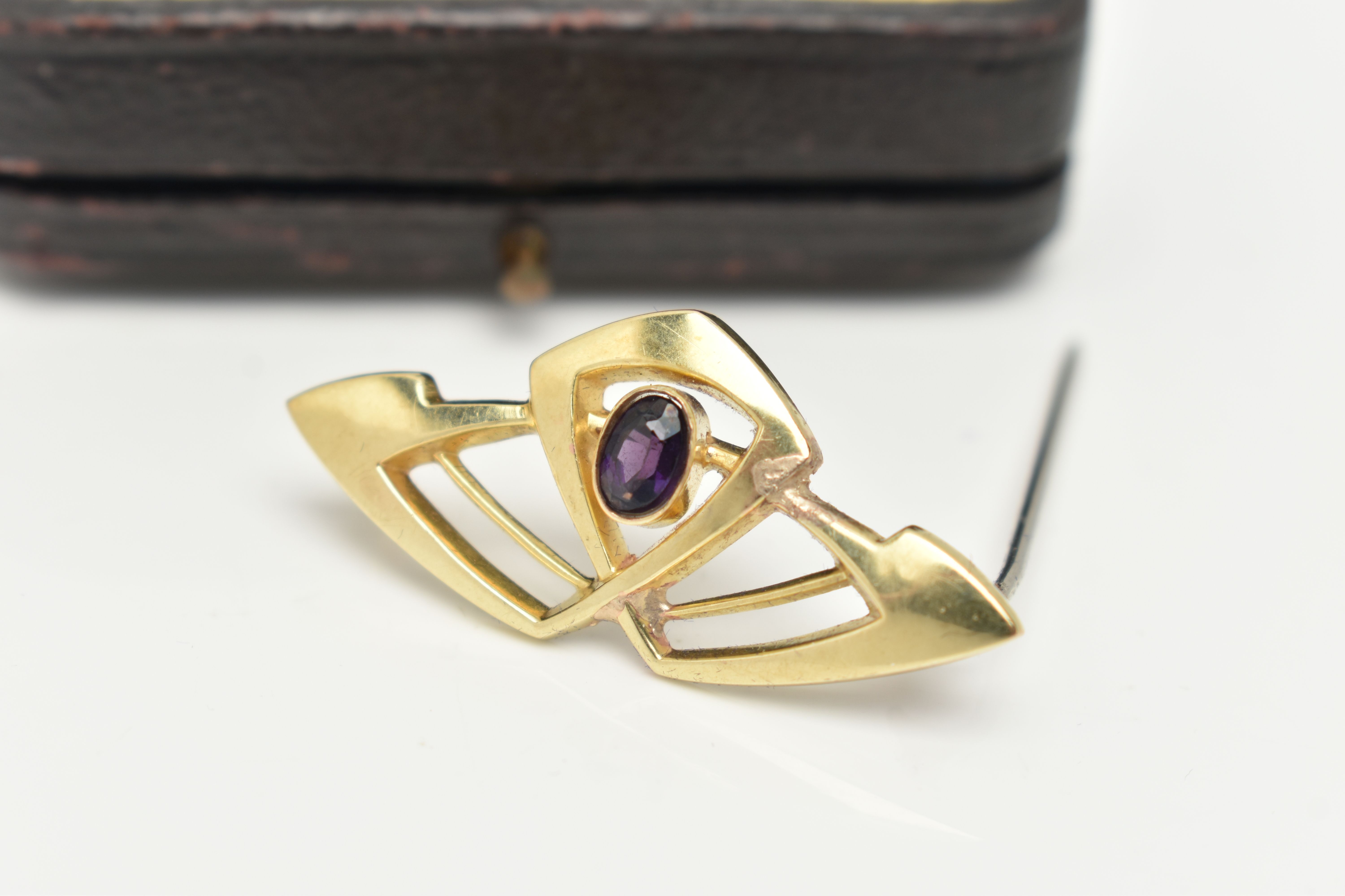 AN AMETHYST BROOCH, of openwork design set with a central oval amethyst, stamped 15ct, length - Image 2 of 3