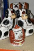 A PAIR OF LATE 19TH / EARLY 20TH CENTURY STAFFORDSHIRE POTTERY SEATED SPANIELS, height 27cm approx.,