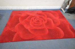 A UPHOLSTERED RUG OF A ROSE, 229cm x 162cm (condition report: in need of cleaning)
