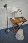 A TEAK FOLDING TRAY TABLE, on a separate stand, along with a Laura Ashley glass table lamp, an