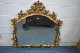 A FLAMBOYANT GILT RESIN OVERMANTEL MIRROR, with scrolled and foliate details, width 116cm x height
