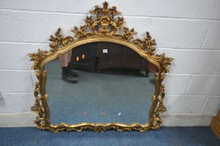 A FLAMBOYANT GILT RESIN OVERMANTEL MIRROR, with scrolled and foliate details, width 116cm x height