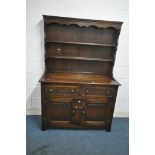 A 20TH CENTURY OAK DRESSER, the two tier plate rack atop a base that's fitted with two drawers,