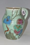 A CLARICE CLIFF 'PASSION FRUIT' SINGLE HANDLED LOTUS JUG, decorated with pink, blue and green