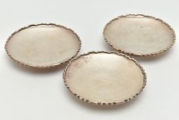 A SELECTION OF THREE SILVER DISHES, each dish with geometric design border, approximate diameter