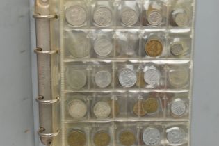 A SMALL COIN ALBUM CONTAINING WORLD COINS TO INCLUDE SOME SILVER CONTENT COINAGE