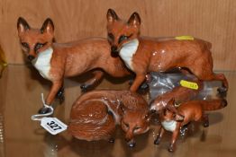 A GROUP OF FOUR BESWICK FOXES, comprising two large Standing Foxes 1016A (one has a broken tail),
