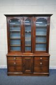A VICTORIAN MAHOGANY BREAKFRONT BOOKCASE, with three glazed sections enclosing adjustable shelves,