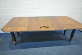 A LATE 19TH / EARLY 20TH CENTURY OAK DROP LEAF WIND OUT DINING TABLE, with three additional