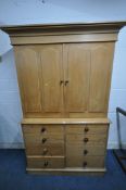A 19TH CENTURY PINE HOUSEKEEPERS CUPBOARD, fitted with double cupboard doors, that are enclosing