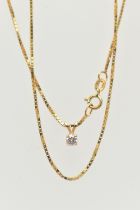 A DIAMOND SINGLE STONE PENDANT WITH YELLOW METAL CHAIN, the pendant set with a round brilliant cut