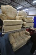 A FLORAL UPHOLSTERED THREE PIECE LOUNGE SUITE, comprising a three seater armchair, and a pair of