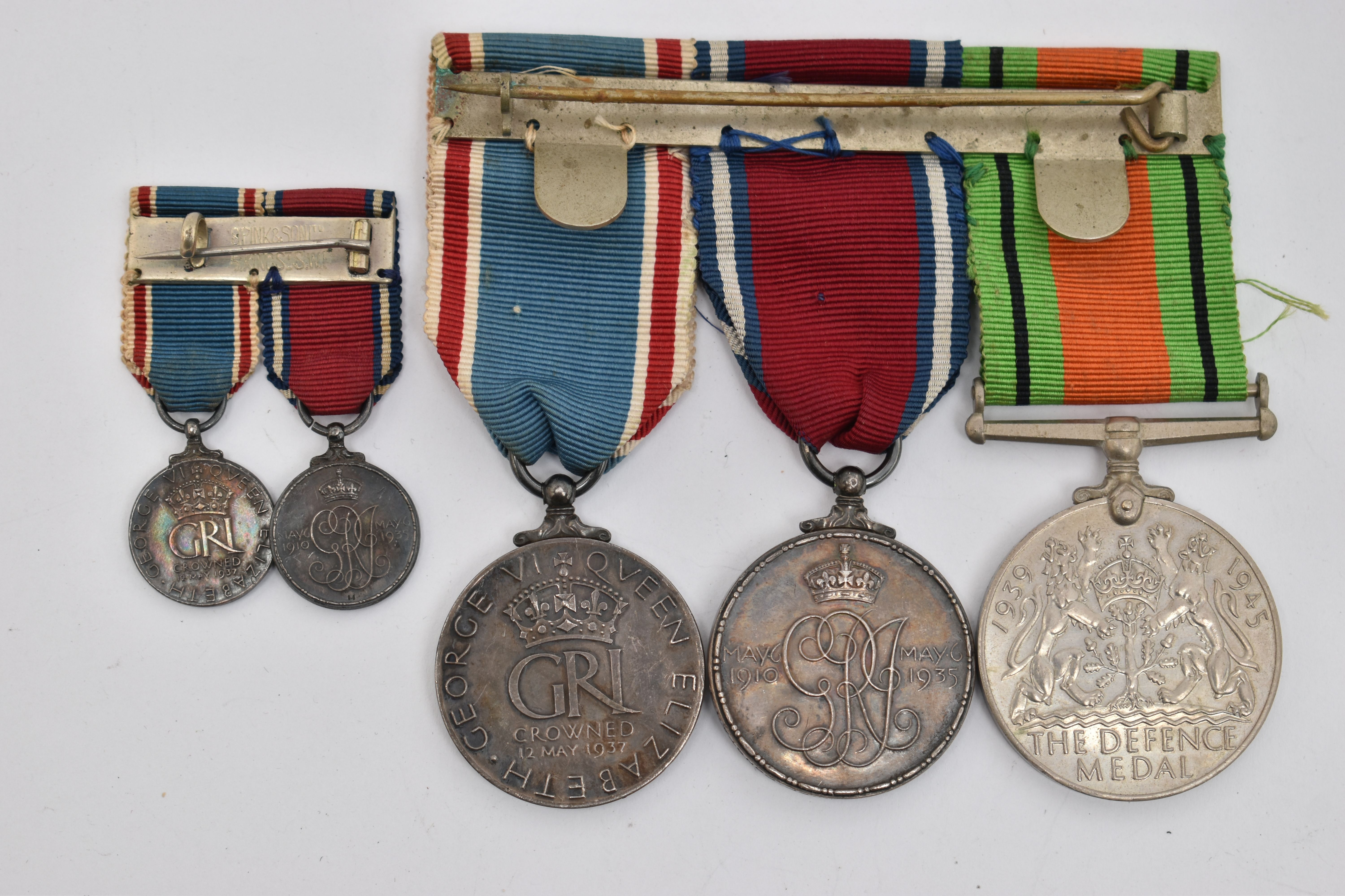 THREE MEDALS AND TWO MINIATURE MEDALS, to include a WWII defense medal, and two 'George V and - Image 2 of 2