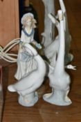 A LARGE NAO TABLE LAMP AND FOUR FIGURINES, comprising a figural table lamp, height 47cm (reglued
