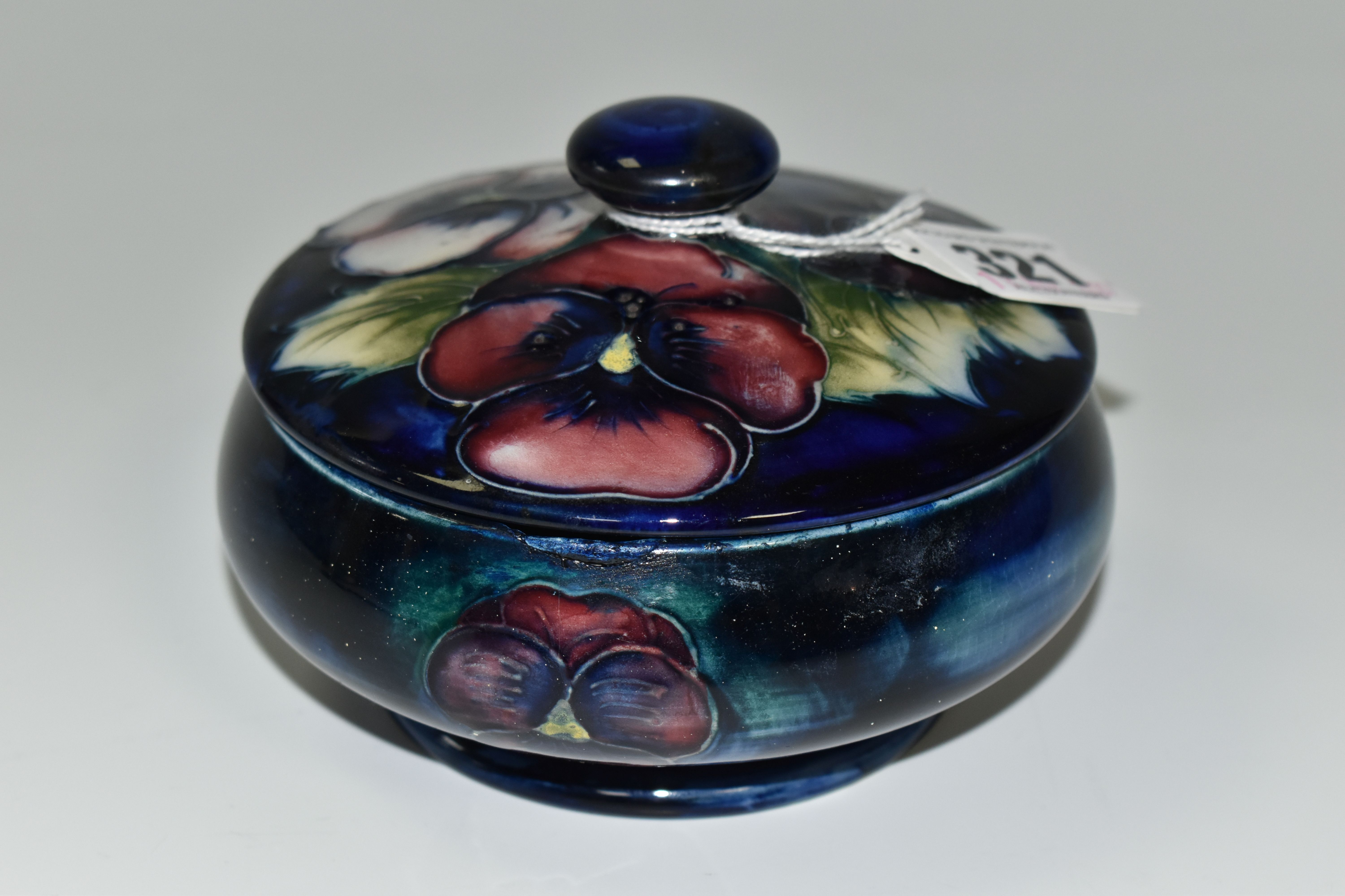 A MOORCROFT POTTERY PANSY DESIGN TRINKET POT, with cover, tube lined with purple and pink flowers on