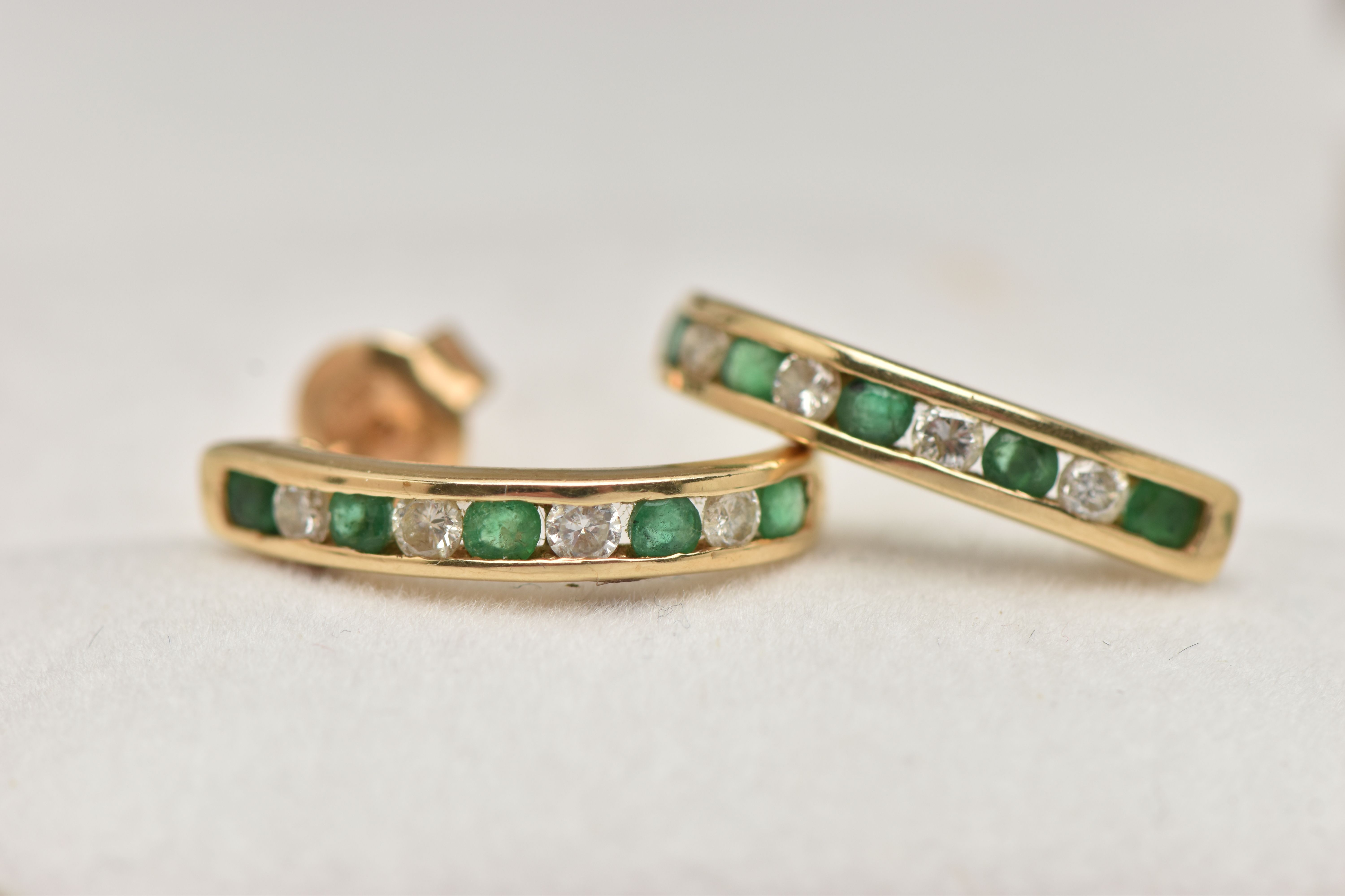 A PAIR OF EMERALD AND DIAMOND EARRINGS, each designed as half hoops channel set with four - Image 2 of 3