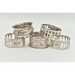 FIVE SILVER NAPKIN RINGS, to include three matching napkin rings with pierced rectangular detail and