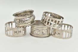 FIVE SILVER NAPKIN RINGS, to include three matching napkin rings with pierced rectangular detail and