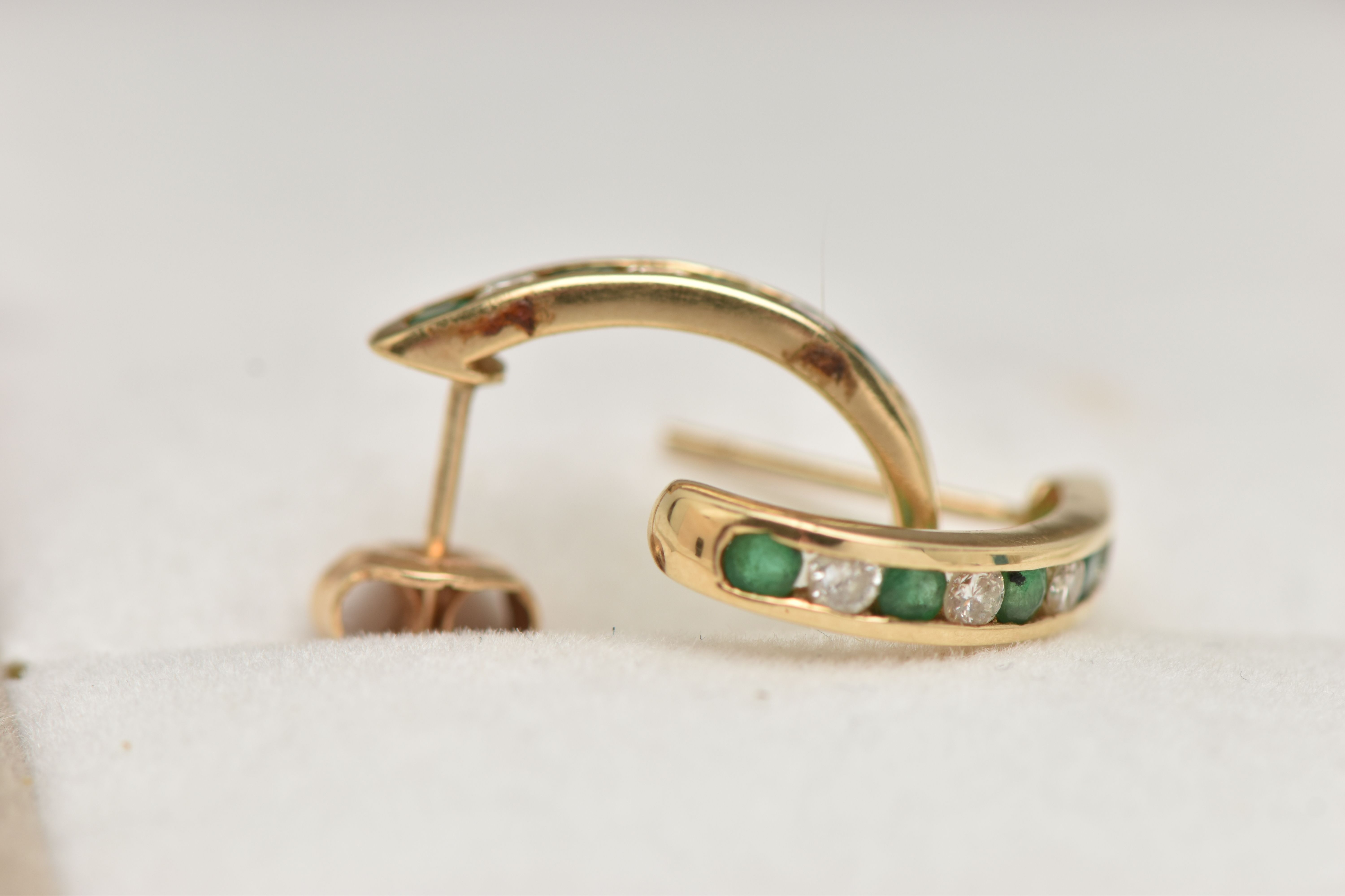 A PAIR OF EMERALD AND DIAMOND EARRINGS, each designed as half hoops channel set with four - Image 3 of 3