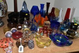 A GROUP OF COLOURED GLASSWARE, including assorted modern paperweights, a handkerchief vase, ashtrays
