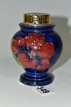 A MOORCROFT TABLE LIGHTER DECORATED WITH DARK PINK HIBISCUS ON A BLUE GROUND, partial remains of a