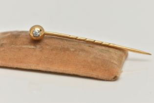 A YELLOW METAL, OLD CUT DIAMOND STICK PIN, polished dome set with an old cut diamond, rub over