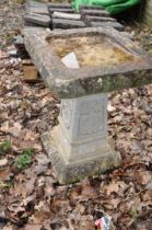 A MODERN COMPOSITE BIRD BATH with tapered square base and 38cm square top height 56cm