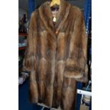 THREE BOXES OF CLOTHING AND SUNDRIES, to include a vintage three quarter length fur coat, a brown
