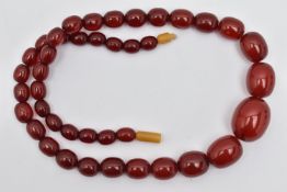 A GRADUATED CHERRY AMBER, BAKELITE BEAD NECKLACE, graduated oval beads, smallest measuring