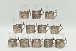 A LATE VICTORIAN SET OF TWELVE LIQUEUR GLASSES, embossed putti scene and acanthus detail, with