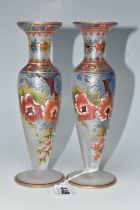 TWO ATLANTIS GLASS FOOTED VASES, painted with flowers and foliate or geometric borders, having