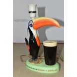 A HAND PAINTED CARLTON WARE GUINNESS ADVERTISING 'TOUCAN' TABLE LAMP, a mid-20th century Guinness