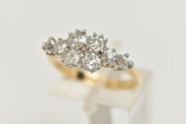 A YELLOW METAL DIAMOND CLUSTER RING, eight old cut diamonds prong set in white metal, approximate