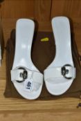 A PAIR OF WHITE GUCCI MULES, with buckle detail, 9cm heel, shop sticker on sole, size 4.5, with